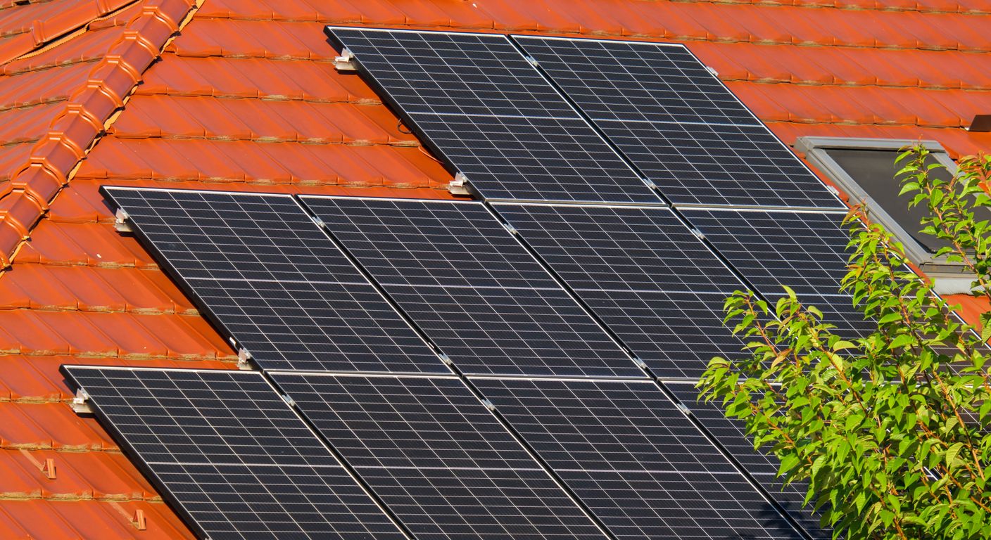 Close-up of solar panels on a red tiled roof